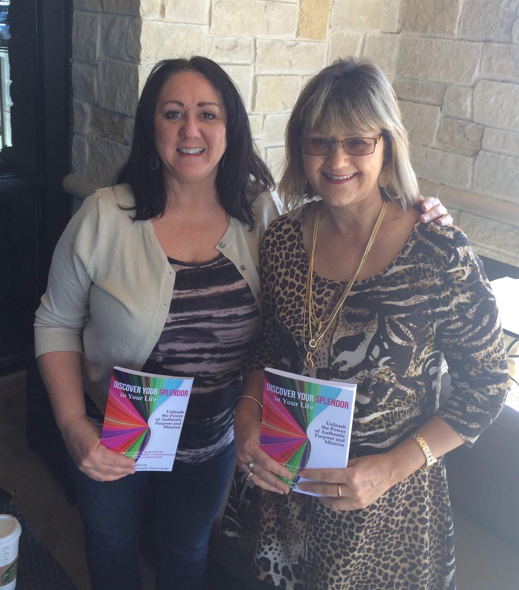 Margo and colleague holding Discover Your Splendor books